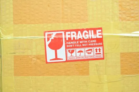 Brown box packaging with warning symbol Foto stock