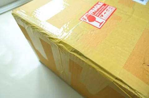 Brown box packaging with warning symbol Stock Photos