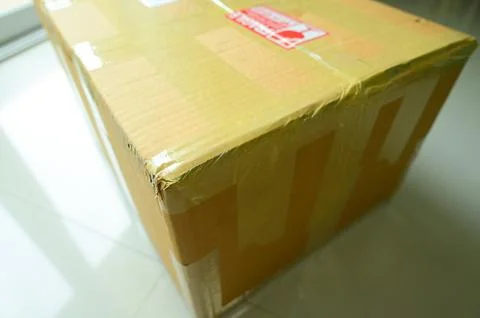 Brown box packaging with warning symbol 스톡 사진