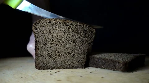 Brown bread cut with a knife in slow motion Stock Footage 132160084