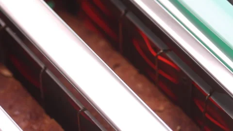Brown bread is fried in a toaster. Close-up. Stock Footage 263056990