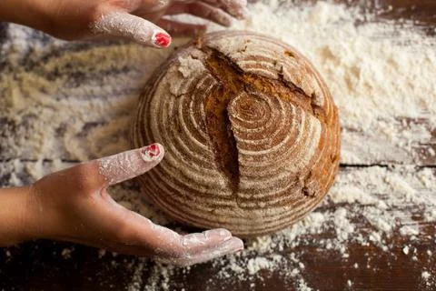 Brown bread in hands Stock Photos