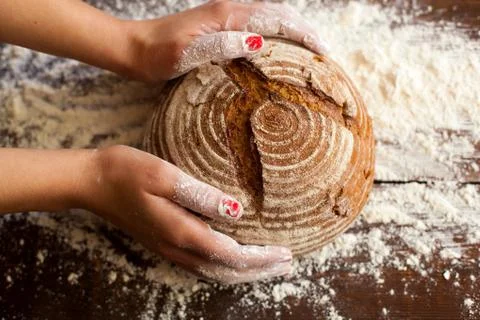 Brown bread in hands Stock Photos