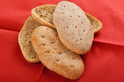 Brown bread on red Stock Photos