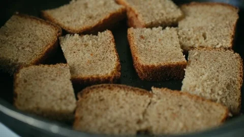 Brown bread slices cooking in a hot pan Видео 337830391