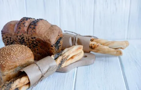 Brown bread, white bread with sesame seeds and bread sticks with sesame seeds Stock Photos