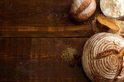 Brown bread on the wooden table Stock Photos