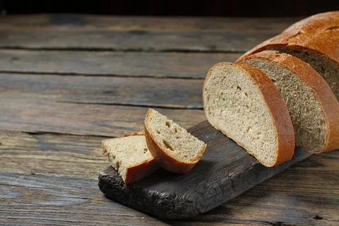Brown bread on a wooden table in a rustic style 스톡 사진