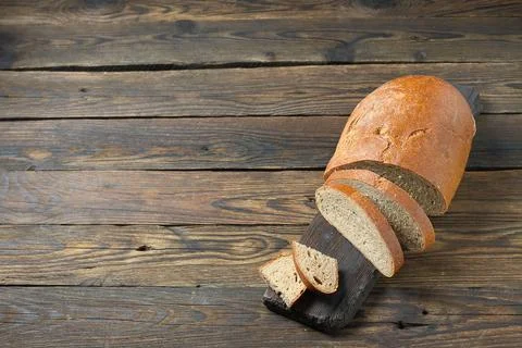 Brown bread on a wooden table in a rustic style 库存照片