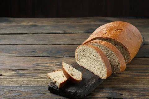 Brown bread on a wooden table in a rustic style Stock-Fotos