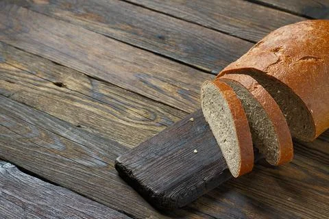 Brown bread on a wooden table in a rustic style Stock-Fotos