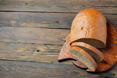 Brown bread on a wooden table in a rustic style 库存照片