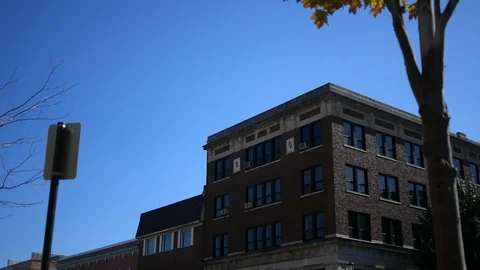 A brown brick building in a small town during daytime Video stock 96465843