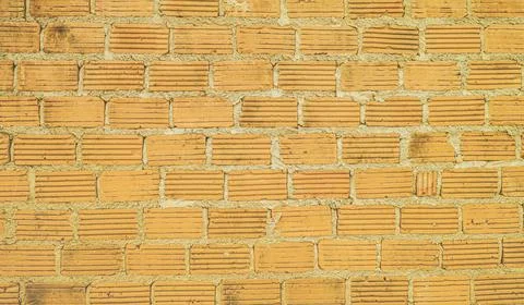 Brown brick wall background Old retro pattern, bright colors. Stock Photos