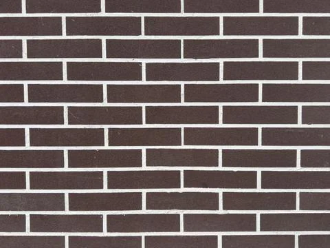 Brown brick wall design with white mortar in an urban setting during daytime Stock Photos