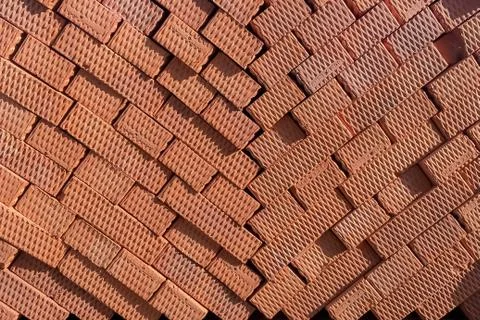 Brown bricks folded into a pile, a background from bricks. Stock Photos