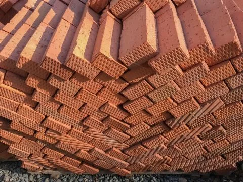 Brown bricks folded into a pile, a background from bricks. Stock Photos