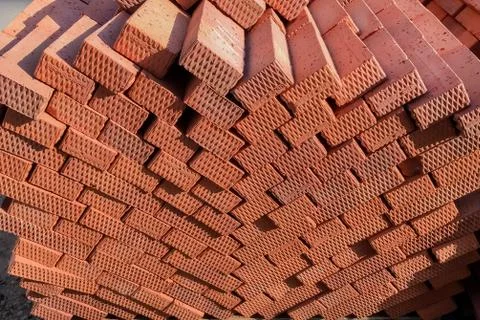 Brown bricks folded into a pile, a background from bricks. Stock Photos