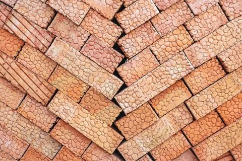 Brown bricks folded into a pile, a background from bricks. Stock Photos