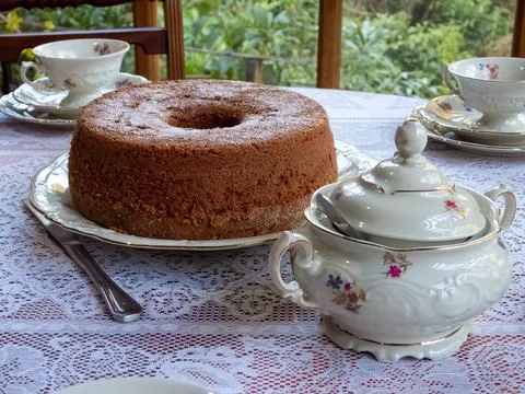 Brown cake on a table with white KPM porcelain tea set Stock Photos