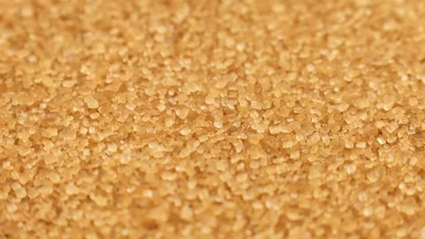 Brown cane sugar crystals circle rotation close up Video stock 276381310