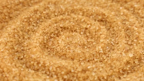 Brown cane sugar crystals texture circle rotation close up Stock Footage 274437907