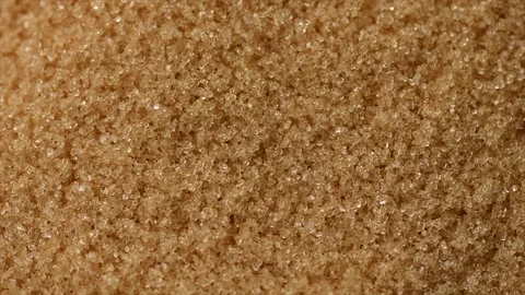 Brown Cane sugar rotating background close up. Brown sugar backdrop, texture Stock Footage 314237492