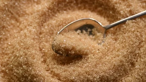 Brown Cane sugar in a spoon close up. Brown sugar background. Heathy eating Stock Footage 314583943