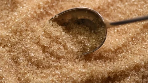 Brown Cane sugar in a spoon close up. Brown sugar background. Heathy eating Stock Footage 314841201