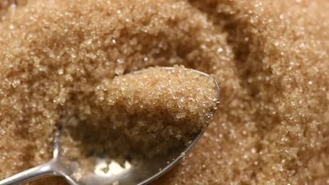 Brown Cane sugar in a spoon close up. Brown sugar background. Heathy eating Stock Footage 314939877
