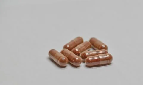 Brown Capsules with astaxanthinon Light Background Stock Photos