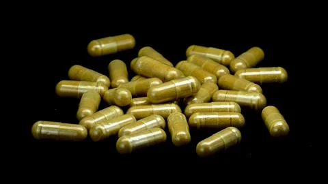 Brown capsules for immunity, 360 degree rotation 스톡 동영상 334593999