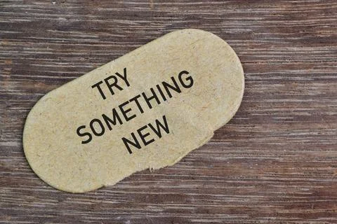 Brown card written with text TRY SOMETHING NEW Stock Photos