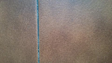 Brown ceramic floor tiles with a single thin dark grout line Stock Photos