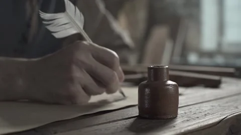 Brown ceramic ink pot on a desk in the blurred background of a master sketching Stock Footage 340823794
