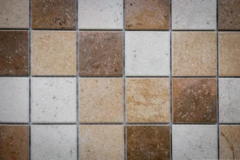 Brown ceramic mosaic on the wall as background Stock Photos
