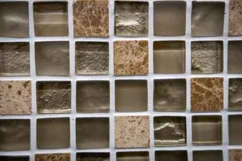 Brown ceramic mosaic on the wall as background Stock Photos