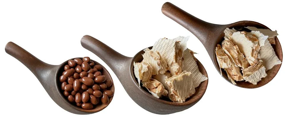 Brown ceramic tableware for sweets with nuts in milk chocolate. Stock Photos