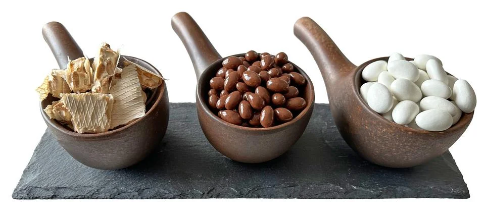 Brown ceramic ware for sweets with nuts in milk chocolate and white chocola.. Stock Photos