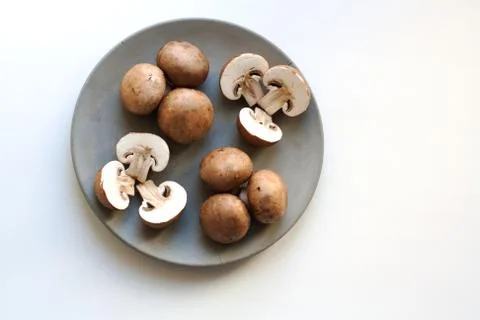 Brown champignons pattern on plate Stock Photos