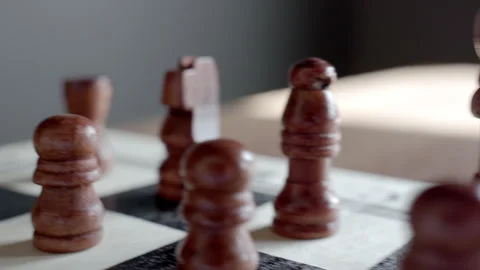 Brown chess pieces on board during game Stock Footage 332637657