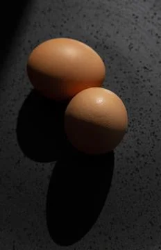 Brown chicken egg on black background Stock Photos