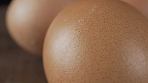 Brown chicken eggs on a dark background Video stock 133244686