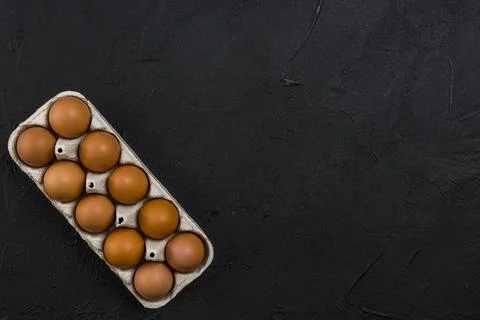 Brown chicken eggs rack black table Stock Photos