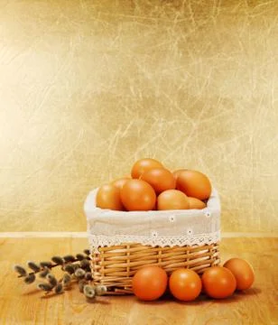 Brown chicken eggs in rustic basket and catkin Stock Photos