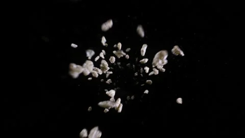 Brown Chocolate cereal crispy flakes fall into frame in slow motion Stock Footage 154144912