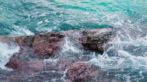 Brown cliffs and crystal clear blue water of sea or ocean. Sea permanently Stock Footage 244156959