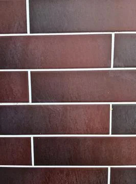 Brown clinker tile wall texture background with white grout lines Stock Photos