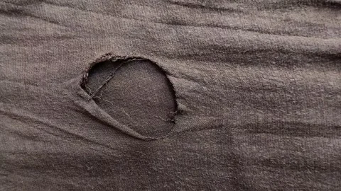 Brown cloth torn and damaged with holes. texture effect Stock Footage 314931503