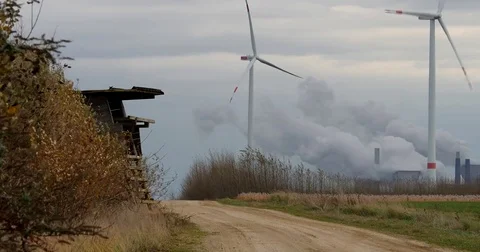 Brown coal power station with wind generators in Germany - UHD 4K Stock Footage 82661823
